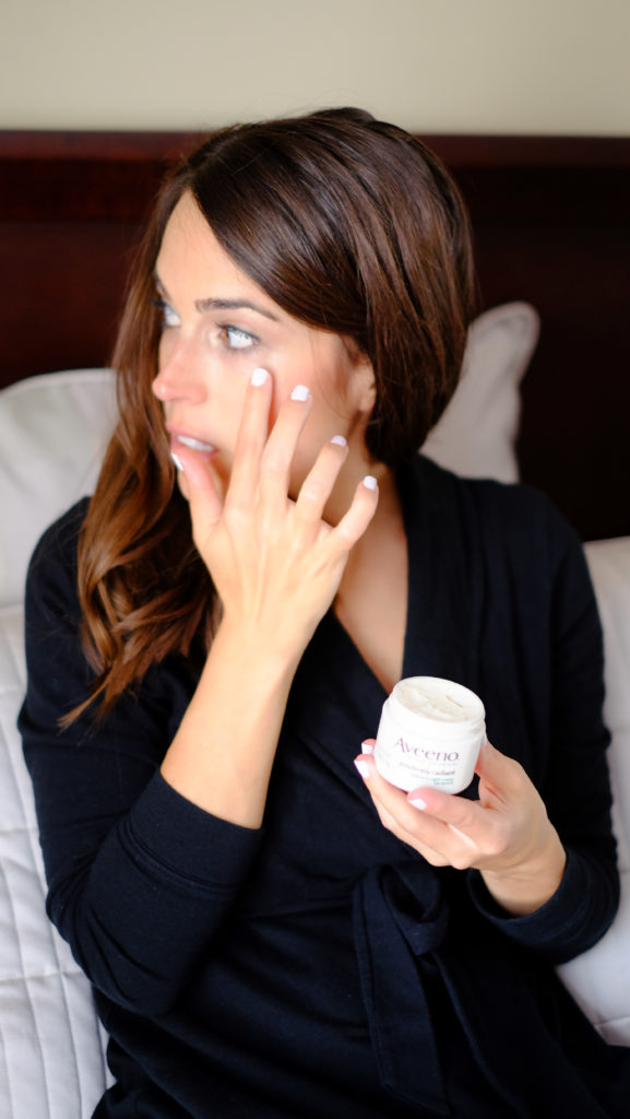 Applying night cream to face